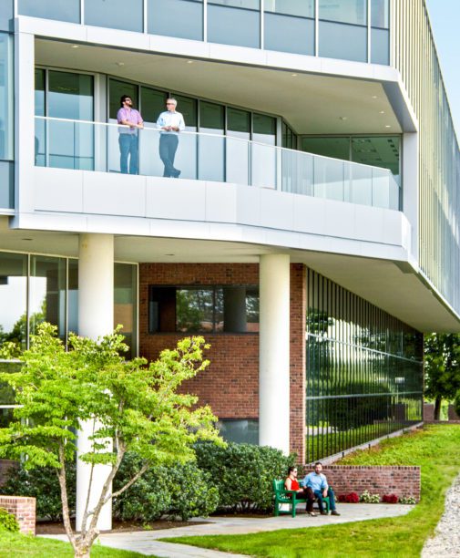 Exterior of Bay Colony with employees enjoying the fresh air.