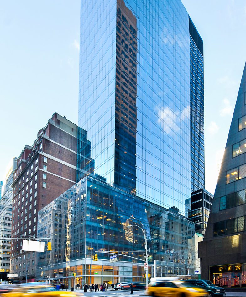 A busy New York City street with 510 Madison Avenue Property in the background