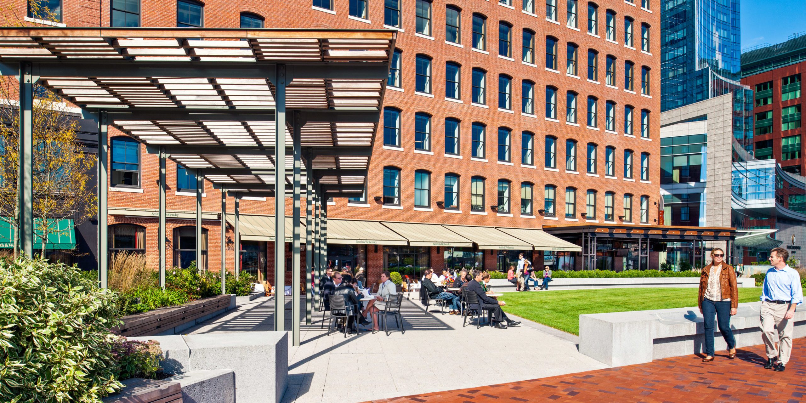 Exterior greenspace of Atlantic Wharf on a bustling afternoon.