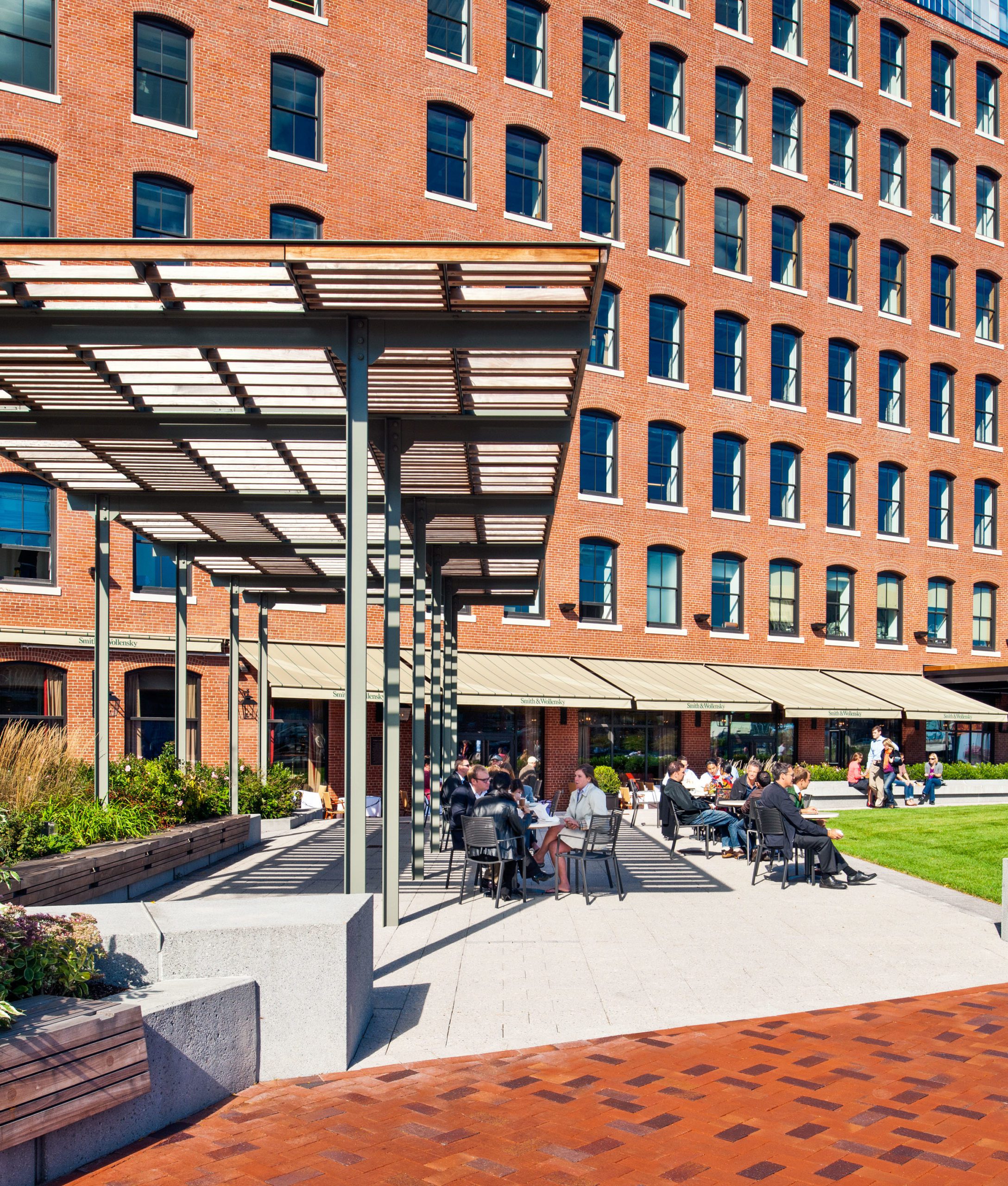 Exterior greenspace of Atlantic Wharf on a bustling afternoon.