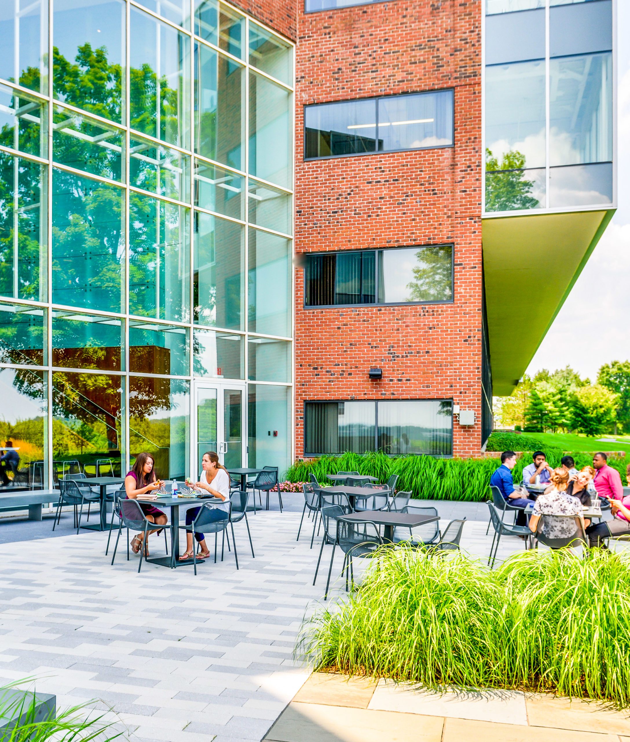 Outside patio of Bay Colony with employees enjoying the fresh air.