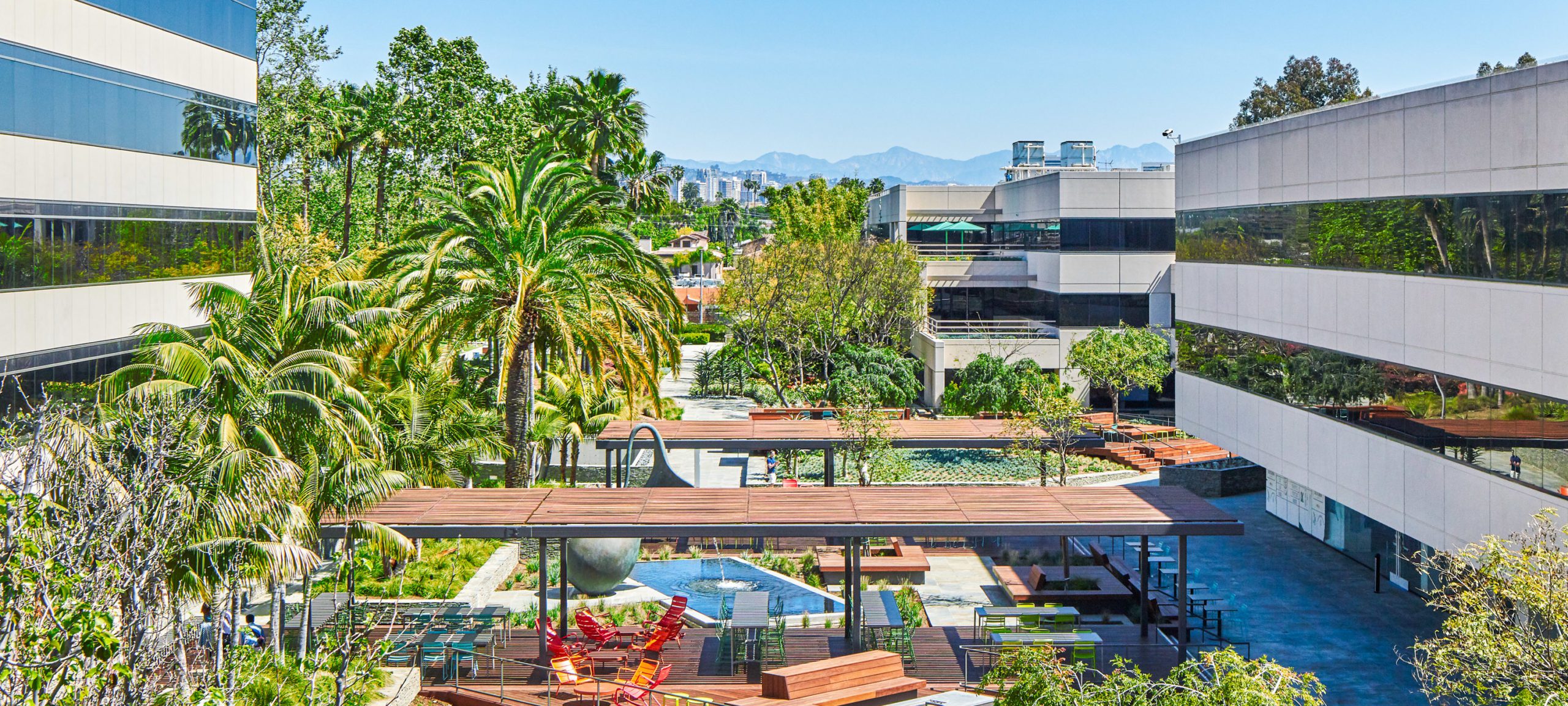 Courtyard at Colorado Center with Palm Trees and mountains in the distance.