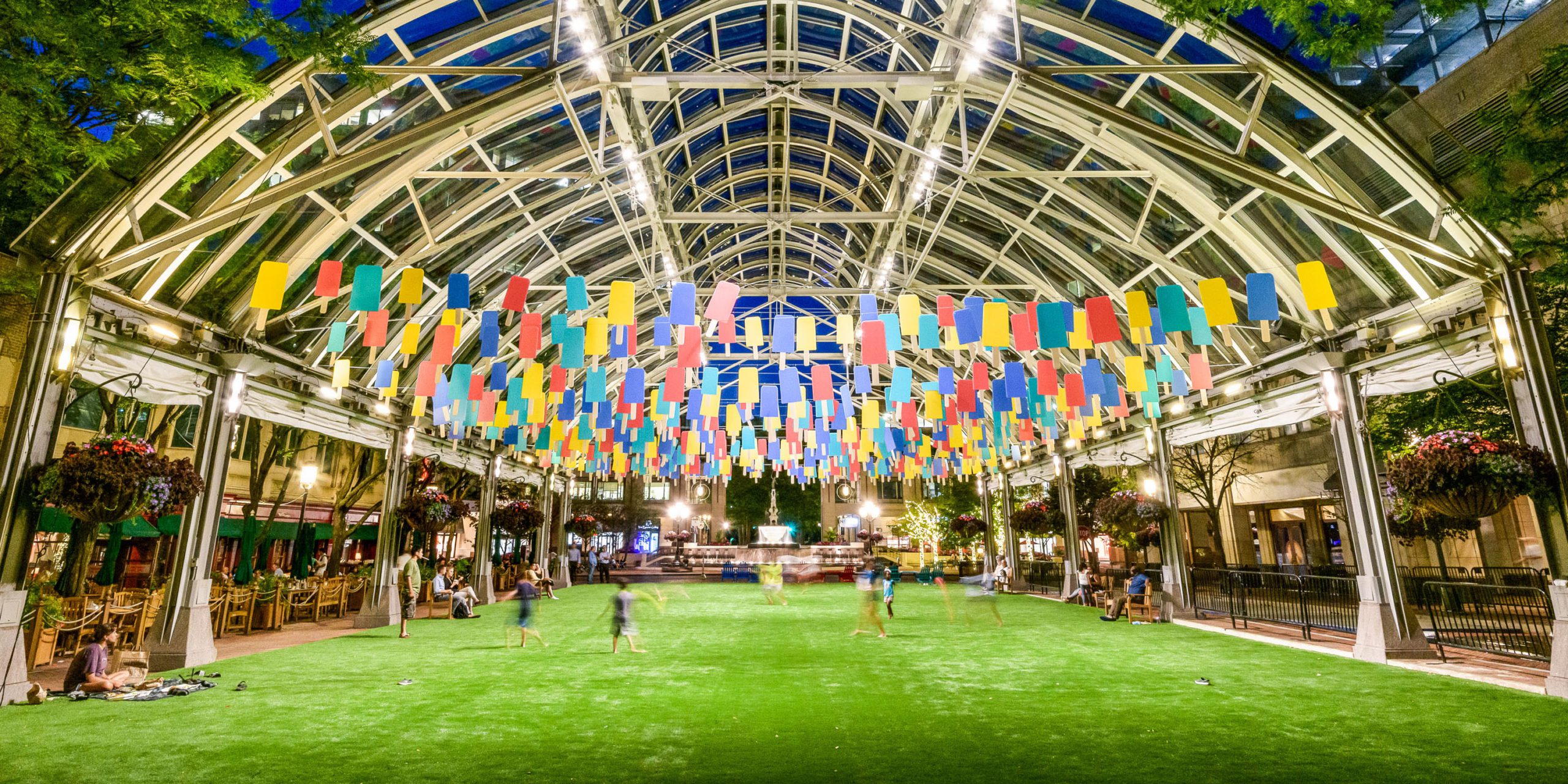 Greenspace at Fountain Square with children playing in the evening