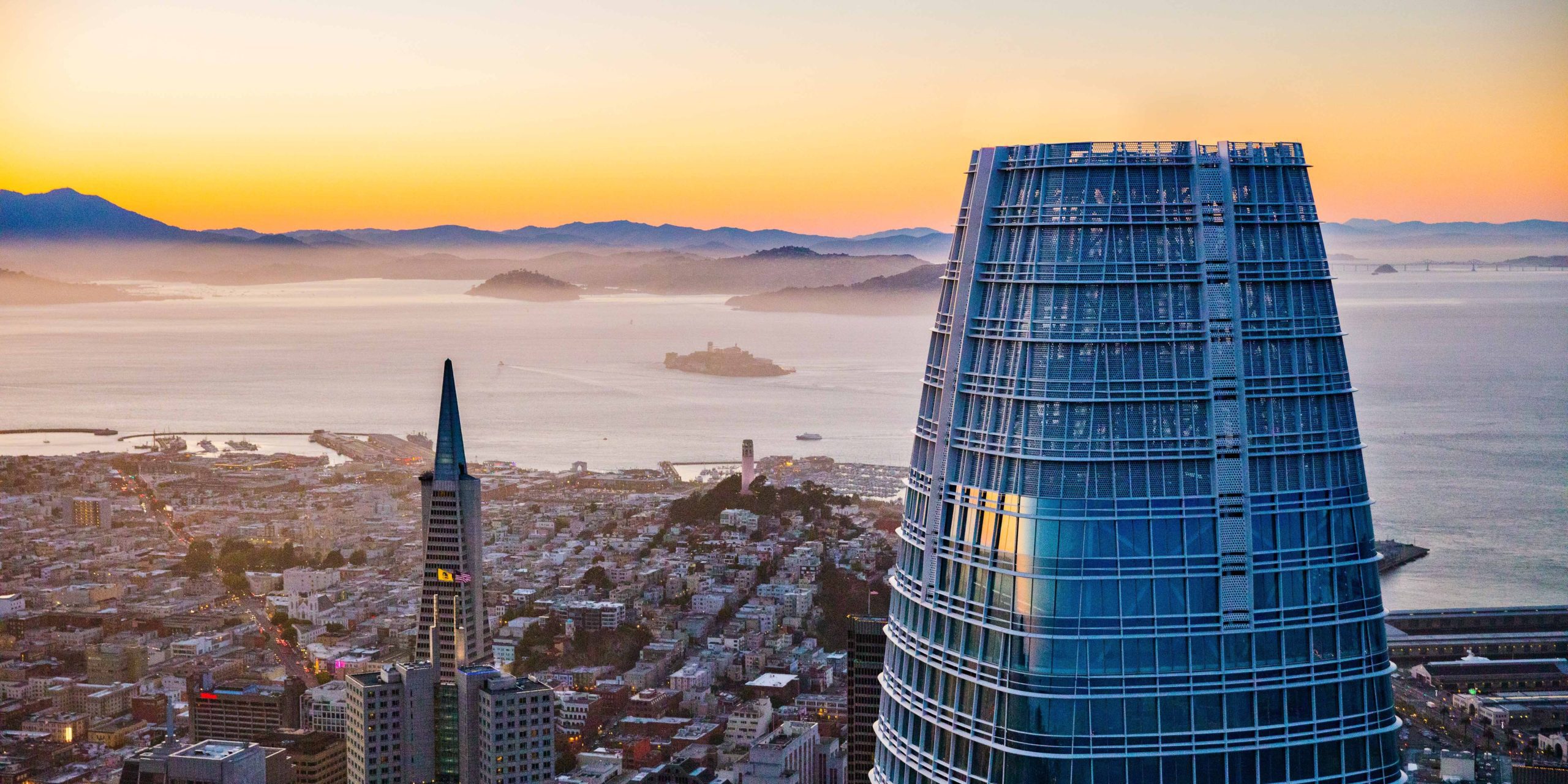 Salesforce Tower overlooking San Francisco at sunset.