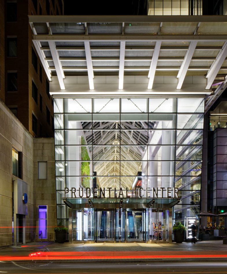 Night image of Prudential Center retail entrance.